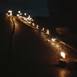 several torches are lit and on the side of the road