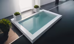 an empty pool that has two planters near it