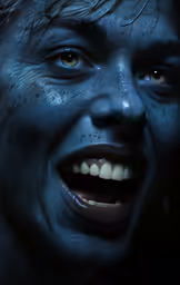 a man with wet paint all over his face is smiling