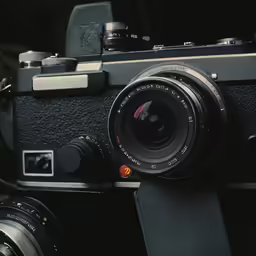 an old film camera, with a lens attached to the back