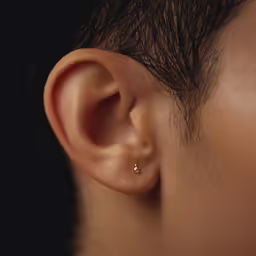 a man with a tiny earring on his right ear