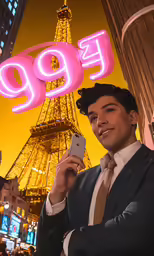 a man standing in front of the eiffel tower holding a cell phone