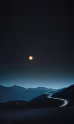 a mountain with a full moon in the sky