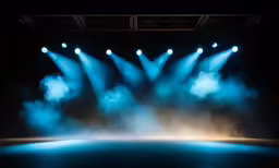 a stage filled with lots of blue lights and smoke