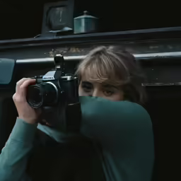 a person holding up a camera to take a photo