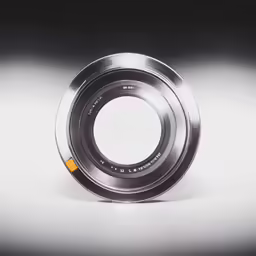 a silver ring with a yellow edge sits on a grey surface