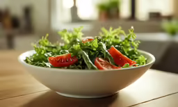 a salad with vegetables in a white bowl