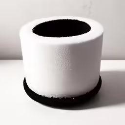 a toilet paper roll sitting on top of a white counter