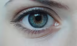 an open green eye with blue and yellow iris