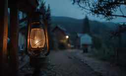 there is a lantern with a light on it near a fence