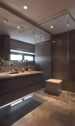 a very spacious bathroom with some sinks and a large mirror