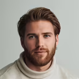 a man with a goatee is looking at the camera