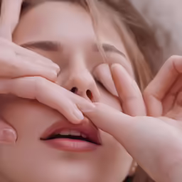 a woman putting her hands together to get a piece of the face ready