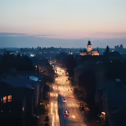 a cityscape has street lights in the foreground