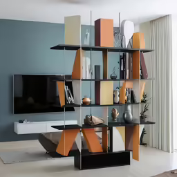 a tv that is sitting on a stand in front of some books