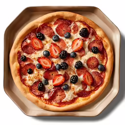 a pizza on a tray with cheese and blackberries