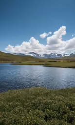 a beautiful mountain is by a small body of water