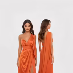a woman in an orange dress standing next to another woman
