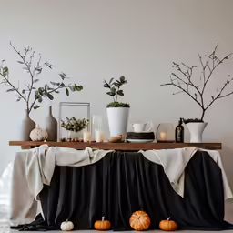 a table covered in black table cloth and decorations