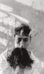 a person in the reflection of another person