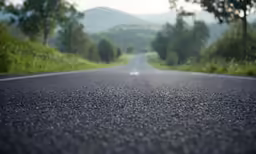 an empty road in the middle of a rural area