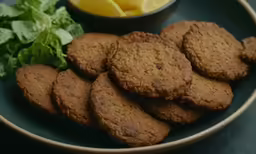 a bunch of cookies sitting on top of a plate next to a bowl