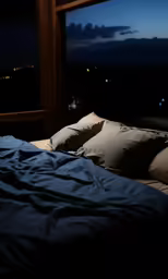 dark bedroom with window and black bedding at night