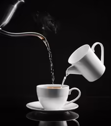 a cup pouring out of it and saucer on top