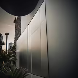 the exterior of a building with large steel doors