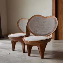 two heart shaped benches are shown in a room