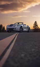 there is a white sports car on the road