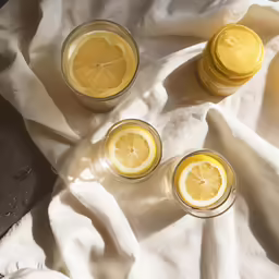 three jars filled with lemon slices next to each other