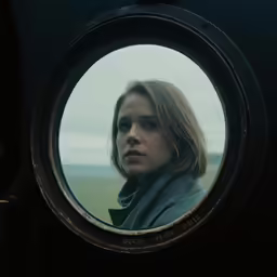 a round looking mirror in the middle of a photo