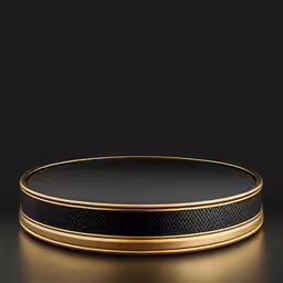 a round black and gold serving dish with metallic rim