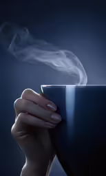 a woman with her hand on a cup of coffee with smoke coming out of it
