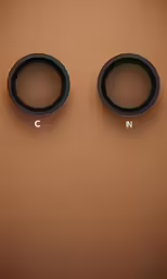 three pairs of ear cups sitting on a brown surface