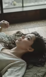 a pretty asian lady laying down on her stomach