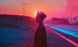 a man standing on the side of the road in the dark