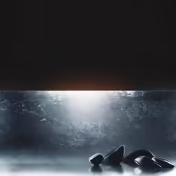 some shoes are laying in the water with watermarked to look like they are falling off