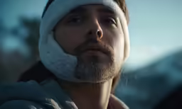 man with hat with beard and eye patch looking at something