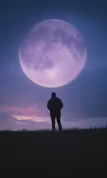 man standing on hill gazing at purple moon
