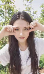 a young woman holding her hands to her head