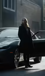 a woman standing next to a car on the road