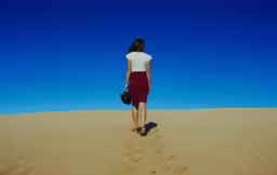 woman standing alone in the desert in a skirt