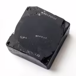 the back of a square black surface with writing on it