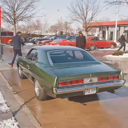 an old time car that is parked on the sidewalk