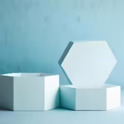 an empty white gift box is in front of the blue wall