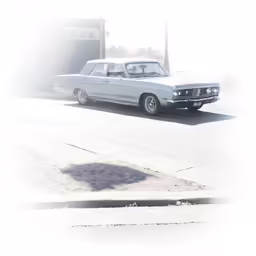 a grey car is parked on a street