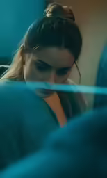 a young lady is looking at her cell phone