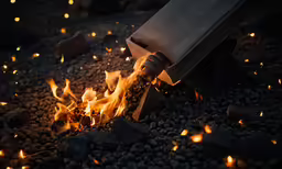 a hammer is about to strike the fire